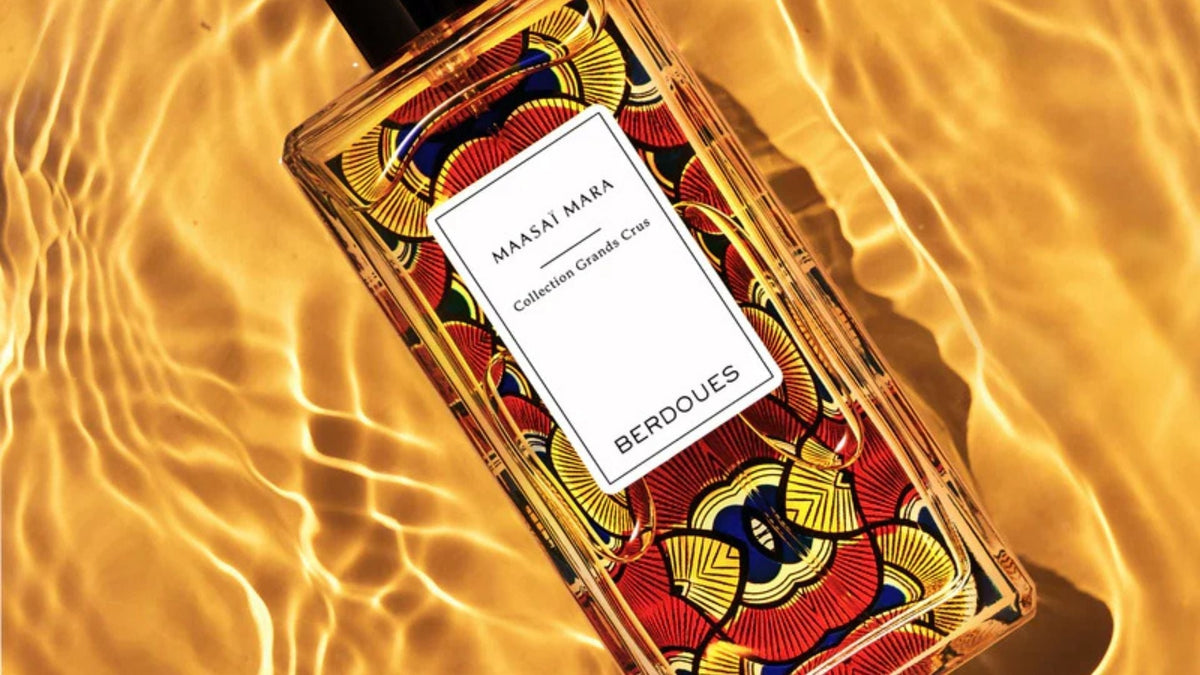 Flacon de parfum Berdoues Maasai Mara de la collection Grands Crus, posé sur une surface dorée aux reflets lumineux, mettant en valeur son design élégant et inspiré de l'Afrique.